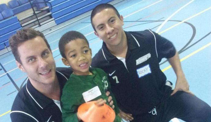 Simon Bratke (left) and Roque Hernandez (right) of the UDC men's soccer team participated in soccer activities with less fortunate children.