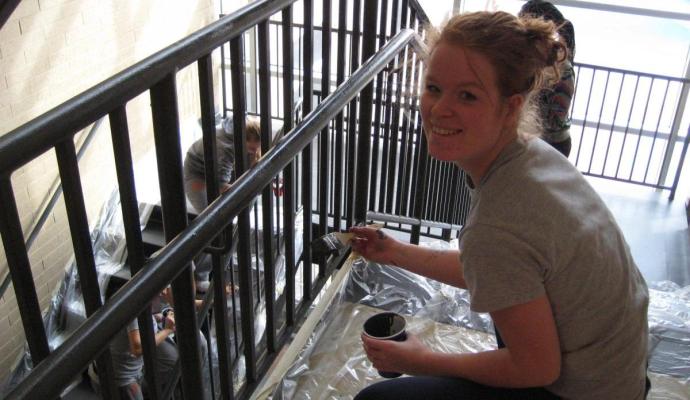 Maxime Duijst and the Firebirds men's and women's tennis teams painted the stairwell railings at Walker Jones Education Campus.
